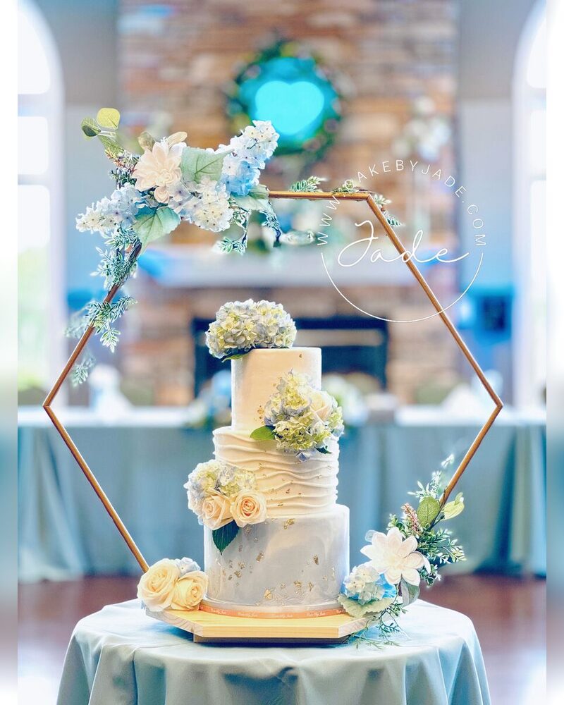 Blue hydrangeas framed by a gold hexagon arch